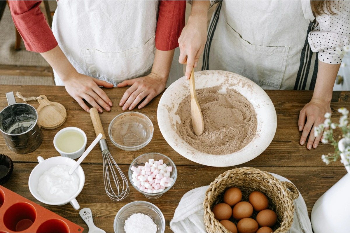 Children's hands decorating baked goods